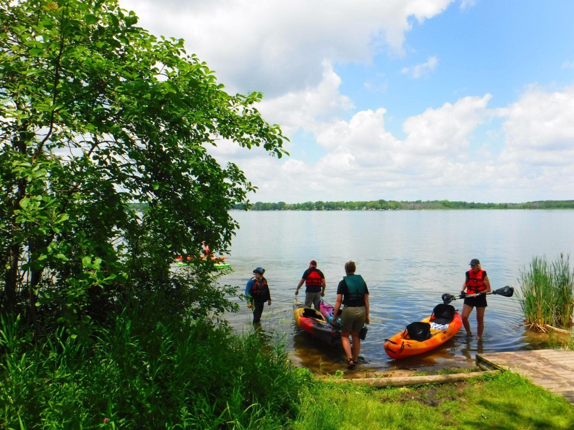 pike lake state park kayak class A group of kayaking students getting to launch their kayaks into a lake.