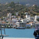 Overlooking the town of Poros, Greece. White stone buildings and arid landscapes.