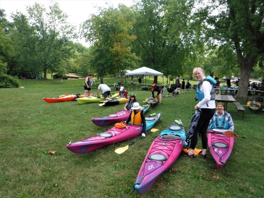 DSCF4411-1024x768 People preparing kayaks in a park-like setting.