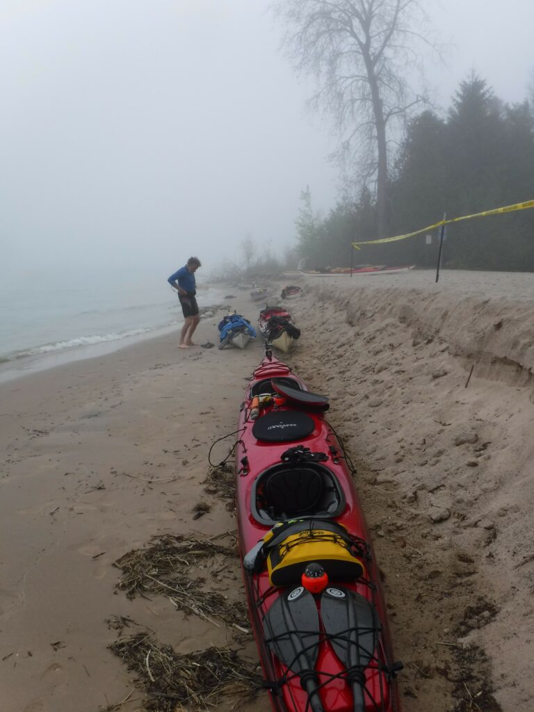 fog-e1557869740818-768x1024 People preparing a kayak on a foggy beach.
