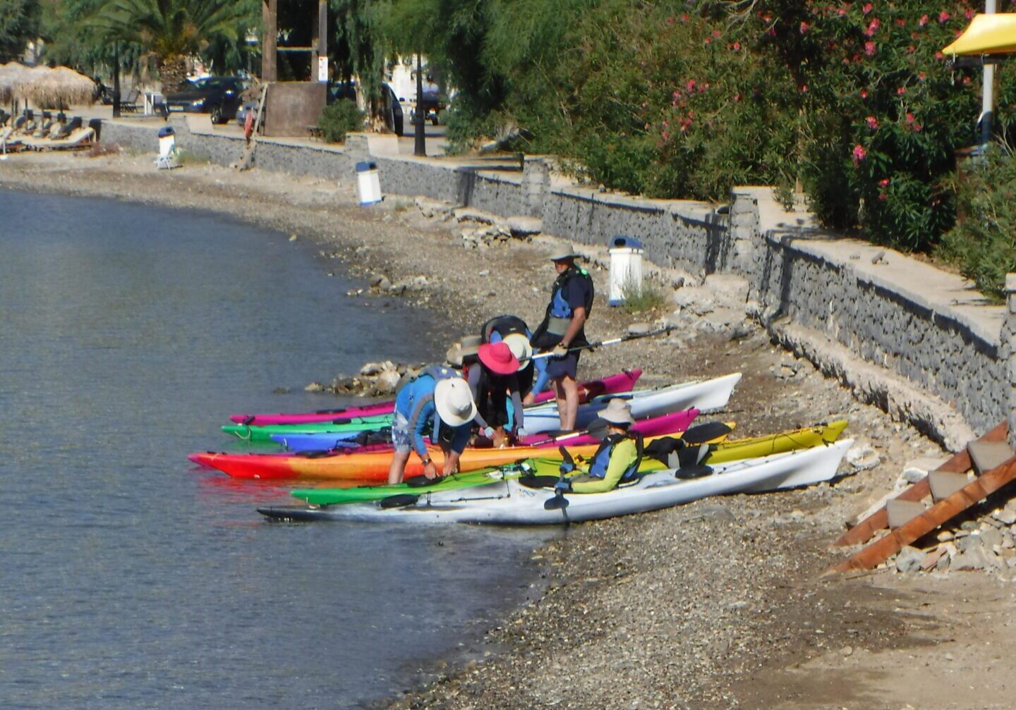 getting ready to launch kayaks from a pebble beach in Poros, Greece