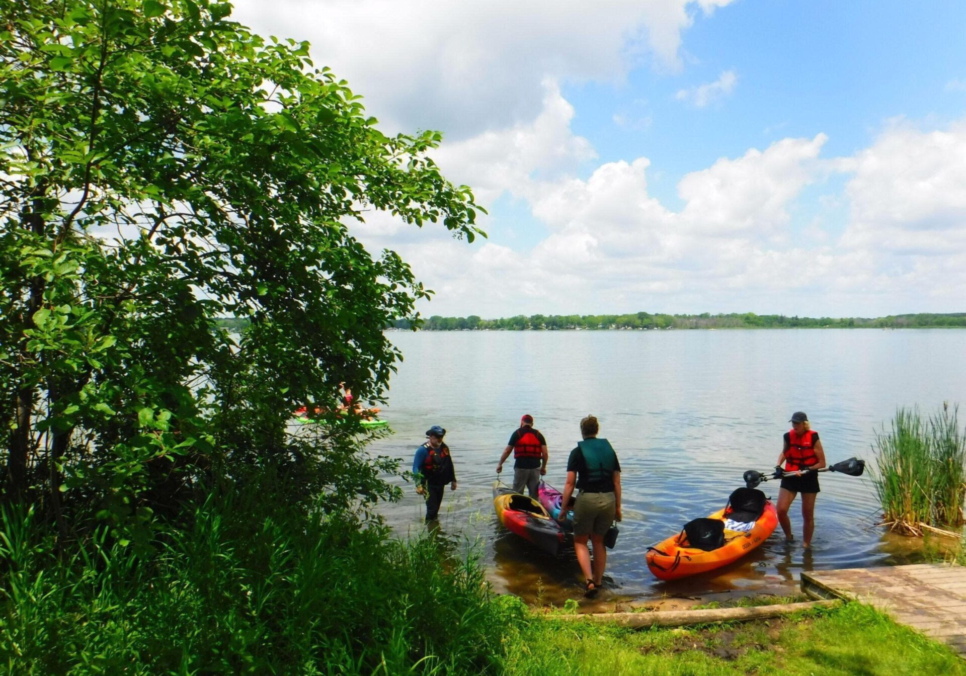 pike lake state park kayak class A group of kayaking students getting to launch their kayaks into a lake.