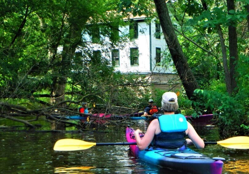 The Waubeka two story historic mill, stands along the shoreline of the Milwaukee river.