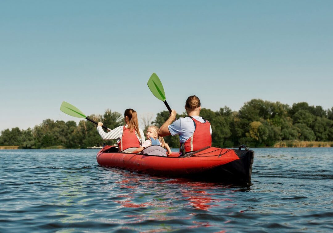 Family kayaking on a calm lake.