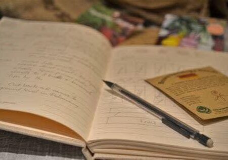 an opened book with a pen on top