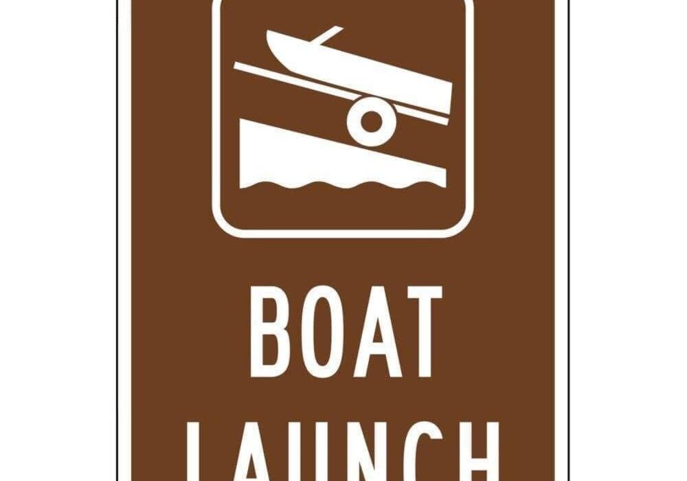 typical boat launch sign - a rectangle with an icon of a boat on a trailer at an angled ramp with water below it. the words "boat launch" at the bottom of the sign