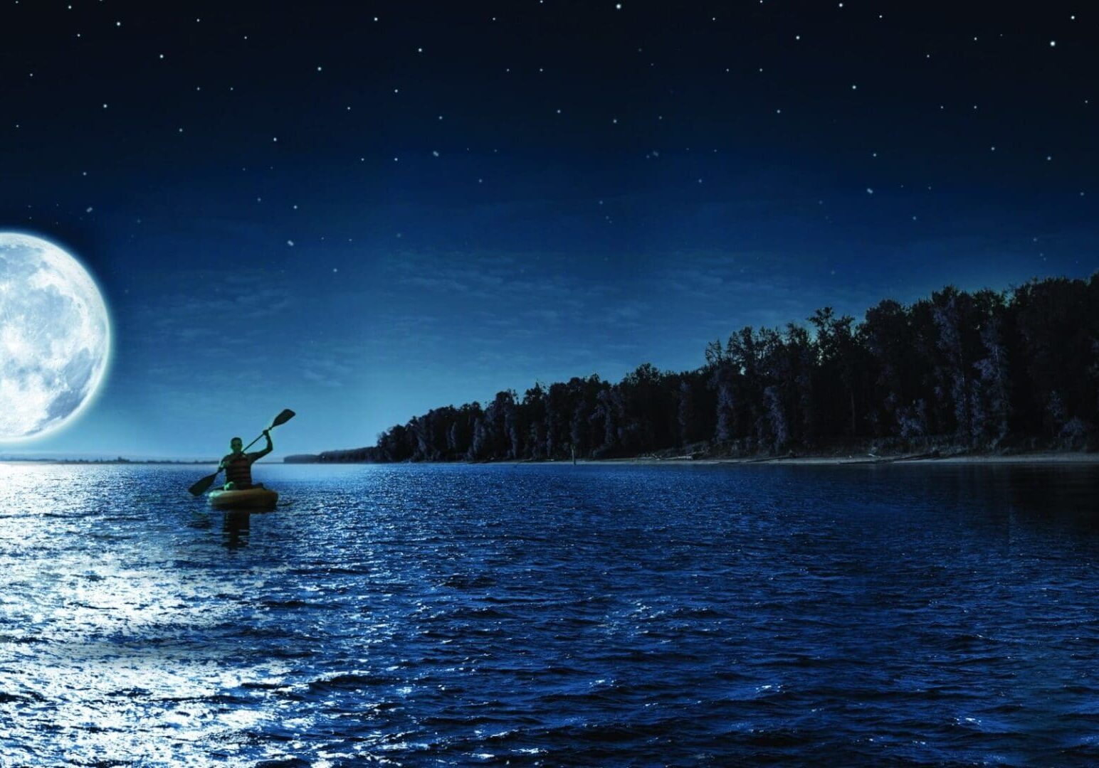 A person kayaking on a moonlit lake at night.